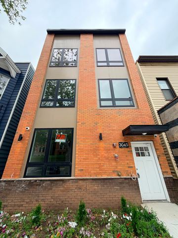 Jersey City apartment for rent - A red brick building with a white door and windows.