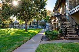 Chico apartment for rent - A sunny day in a quiet residential neighborhood with houses and green lawns.