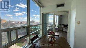 Markham (Aileen-Willowbrook) condo for rent - A dining room with a table set for two and a view of the city through the windows.