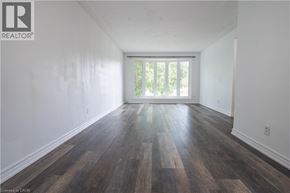 Waterloo apartment for rent - A room with wooden flooring and a window.