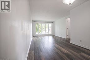 Waterloo apartment for rent - A room with wooden floors and white walls.