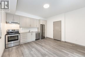 Hamilton (Landsdale) multi-family for rent - A kitchen with a stove top oven, sink, and refrigerator.