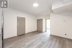 Hamilton (Landsdale) multi-family for rent - A spacious room with wooden flooring and two doors.