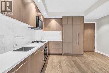 Vancouver apartment for rent - A modern kitchen with wooden cabinets and a white countertop.