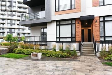Richmond Hill townhouse for rent - A modern house with a black and white exterior and a brown door.