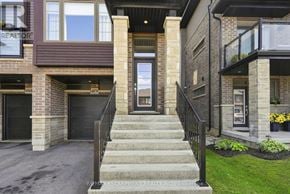 Lincoln (Beamsville) townhouse for rent - A house with a brown facade and a black railing on the stairs.