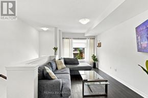 Lincoln (Beamsville) townhouse for rent - A living room with a grey couch and a coffee table.