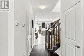Lincoln (Beamsville) townhouse for rent - A hallway with a staircase and a white door.