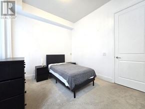 Toronto (Bay Street Corridor) condo for rent - A bedroom with a bed, nightstand, and wardrobe.