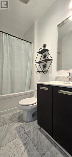 Toronto (Bay Street Corridor) condo for rent - A bathroom with a toilet, sink, and a mirror.