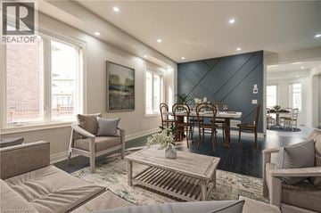 Milton apartment for rent - A living room with a grey couch, a wooden coffee table, and a dining table with chairs.