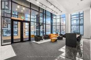 Ottawa condo for rent - A modern office lobby with a black reception desk and orange chairs.