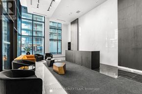 Ottawa condo for rent - A modern office space with black and white decor and a glass wall.