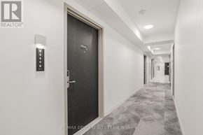 Ottawa condo for rent - A hallway with a black door and a keypad on the wall.