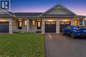Wellington townhouse for rent - A blue car is parked in front of a house with a realtor logo.