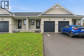 Wellington townhouse for rent - A blue car is parked in front of a house with a garage.