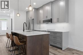 Wellington townhouse for rent - A modern kitchen with a center island and chairs.