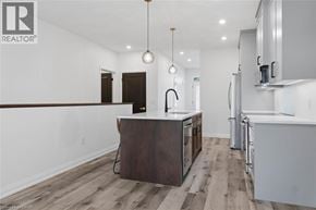 Wellington townhouse for rent - A modern kitchen with a center island and stainless steel appliances.