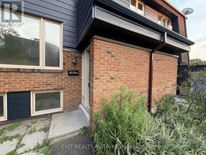 Ottawa townhouse for rent - A brick house with a window and a door.