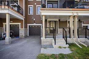 Ottawa townhouse for rent - A modern two-story residential building with a balcony on the upper floor.
