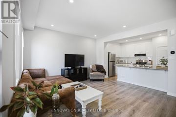 Ottawa townhouse for rent - A modern living room with a brown leather couch and a white coffee table.