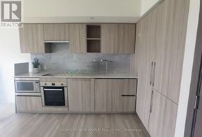 Toronto (Waterfront Communities) condo for rent - A modern kitchen with wooden cabinets and stainless steel appliances.