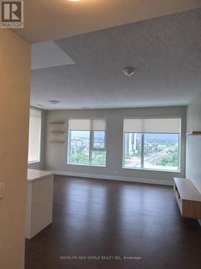 Markham (Unionville) condo for rent - A room with a window overlooking a cityscape.
