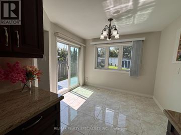 Mississauga (Rathwood) apartment for rent - A kitchen with a brown counter top and a chandelier.
