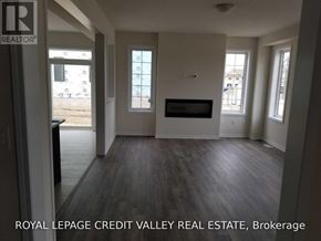 Haldimand apartment for rent - A living room with a fireplace and a tv on the wall.