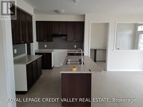 Haldimand apartment for rent - A kitchen with dark brown cabinets and a white countertop.