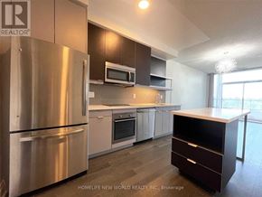 Toronto (Willowdale East) condo for rent - A modern kitchen with stainless steel appliances and a wooden island.