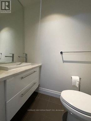 Toronto (Willowdale East) condo for rent - A white toilet sits next to a sink in a bathroom.