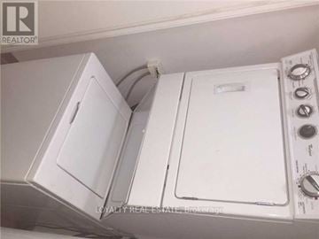 Toronto (Niagara) condo for rent - A white oven and microwave are installed in a kitchen.