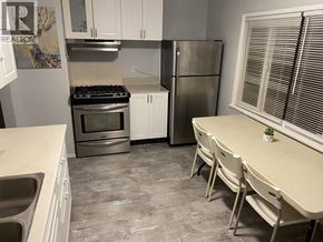 Vancouver apartment for rent - A kitchen with white cabinets and a tiled floor.