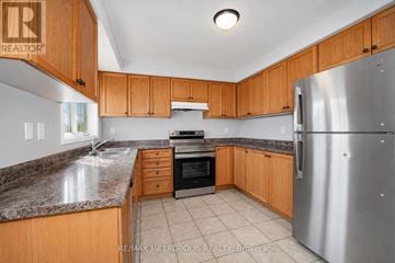 Ajax (Central East) apartment for rent - A kitchen with wooden cabinets and a granite countertop.