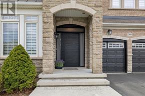 Oakville (Wm Westmount) apartment for rent - A house with a black front door and a stone archway.