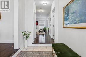 Oakville (Wm Westmount) apartment for rent - A hallway with a green couch and a painting on the wall.
