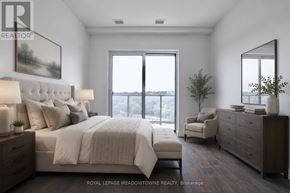Cambridge condo for rent - A bedroom with a large bed, a chair, and a painting on the wall.