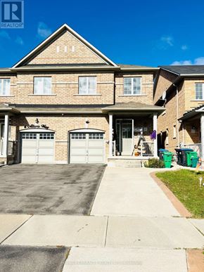 Brampton (Bram East) apartment for rent - A house with a brown brick facade and a white garage door.