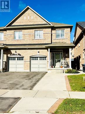 Brampton (Bram East) apartment for rent - A house with a brown brick facade and a white garage door.
