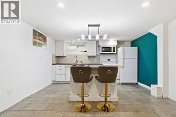 Windsor apartment for rent - A kitchen with white cabinets and a white refrigerator.
