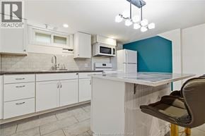 Windsor apartment for rent - A kitchen with white cabinets and a blue accent wall.