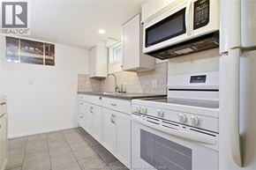 Windsor apartment for rent - A kitchen with white appliances and cabinets.