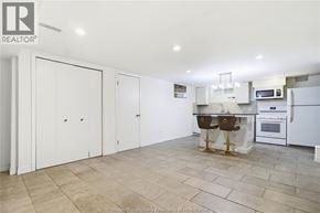 Windsor apartment for rent - A kitchen with white cabinets and a tile floor.