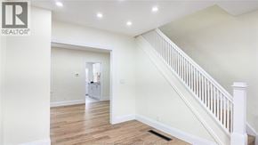 Windsor apartment for rent - A spacious room with a staircase leading to the upper floor.