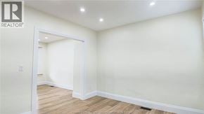 Windsor apartment for rent - A white room with a wooden floor and a doorway leading to another room.