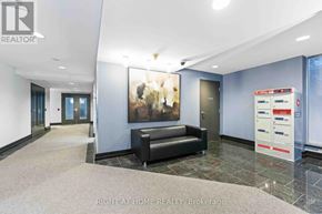 Ottawa condo for rent - A brokerage office with a black couch and a painting on the wall.