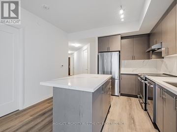 Vaughan (Vellore Village) condo for rent - A kitchen with a white counter top and stainless steel appliances.