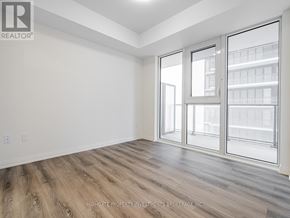 Vaughan (Vellore Village) condo for rent - A room with a sliding glass door and wooden flooring.