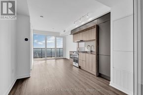 Mississauga (City Centre) condo for rent - A well-lit kitchen with wooden floors and a large window.